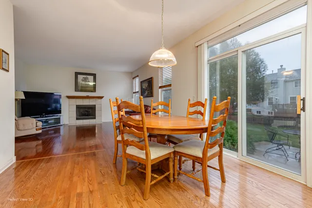 a dining room with furniture and wooden floor