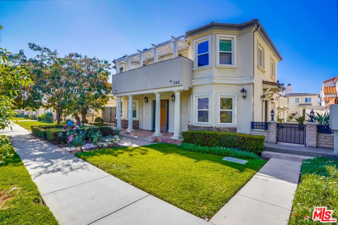 a view of a house with backyard sitting area and garden
