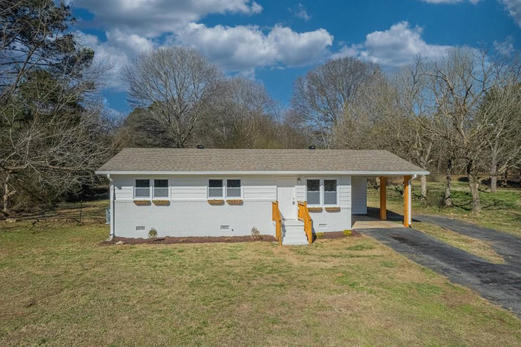 7630 Royston Road Carnesville, GA 30521 - Photo 1 of 1 a view of a house with backyard and trees
