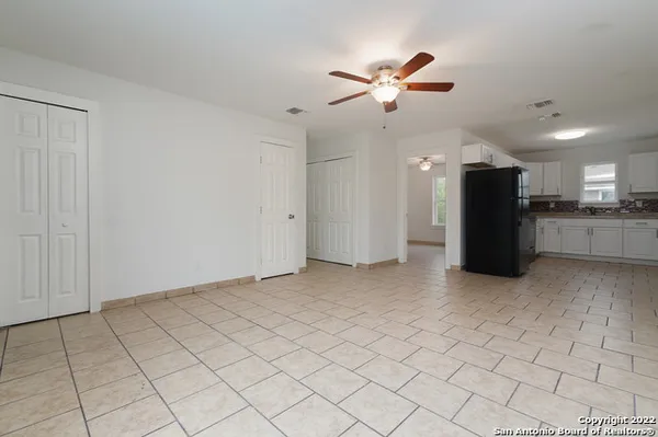 a view of a kitchen with a sink and a chandelier fan