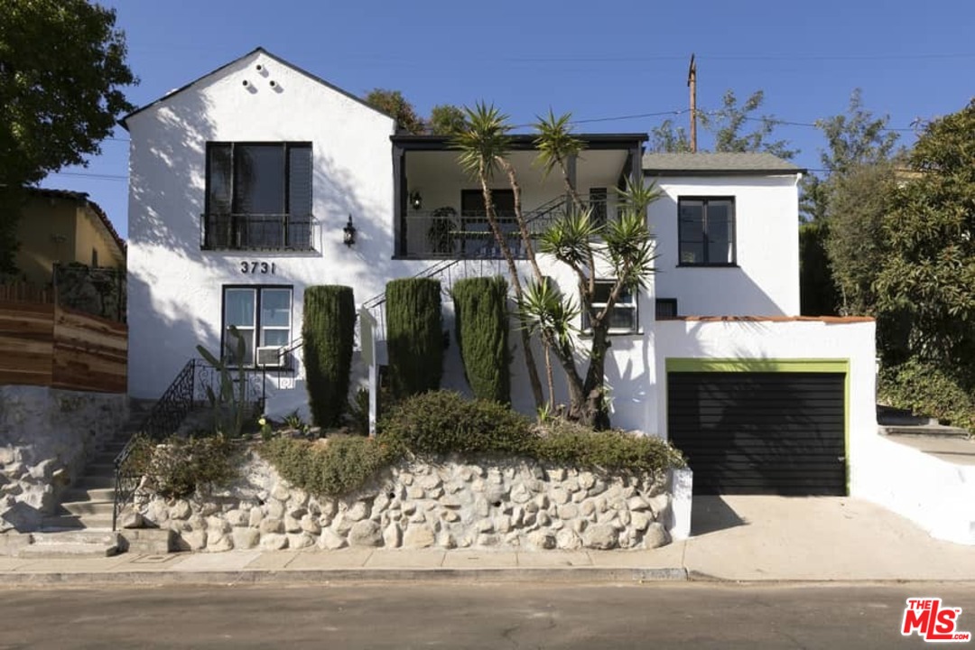 a front view of a house with yard