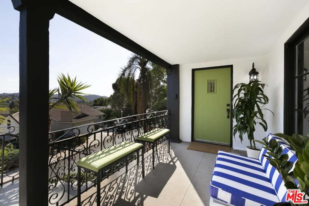 3729 Roderick Road Los Angeles, CA 90065 - Photo 3 of 40 a balcony with furniture and a potted plant