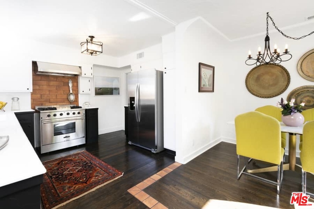 3729 Roderick Road Los Angeles, CA 90065 - Photo 10 of 40 a kitchen with stainless steel appliances granite countertop a refrigerator a stove a sink dishwasher and a stove with wooden floor