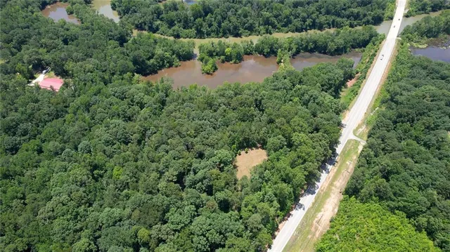 an aerial view of a house with a yard and street view