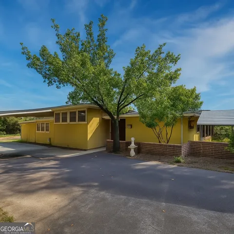 a front view of a house with a yard and a garage