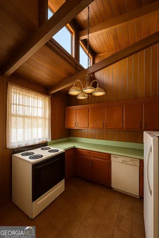 a kitchen that has a sink and a stove top oven