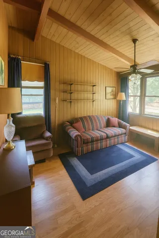 a living room with a couch wooden floor and a table