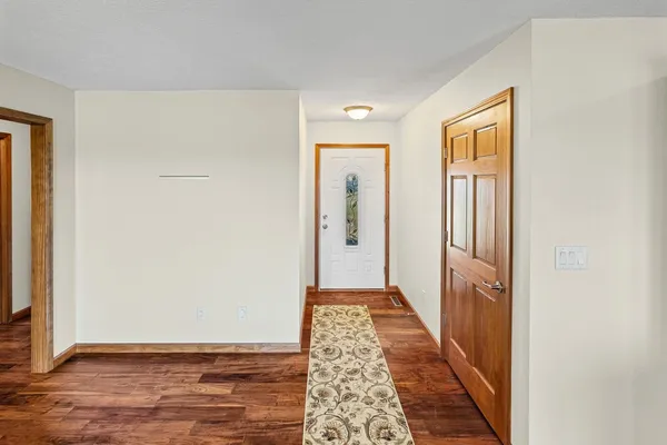 a view of hallway with wooden floor