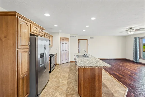 a view of a kitchen with a refrigerator and a sink