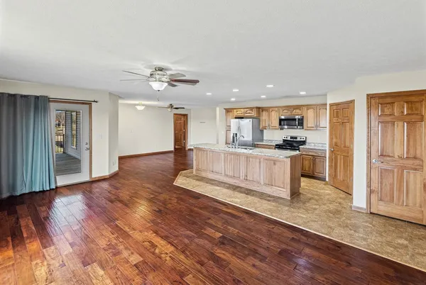 a large kitchen with cabinets and wooden floor