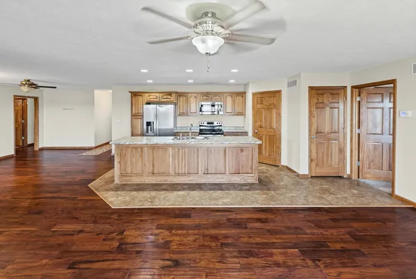 a view of kitchen with granite countertop cabinets and wooden floor
