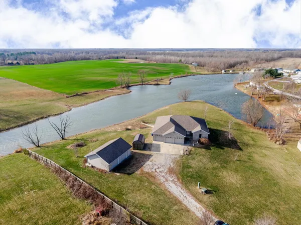 an aerial view of a house with a big yard