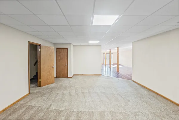 a view of a room with wooden floor and window