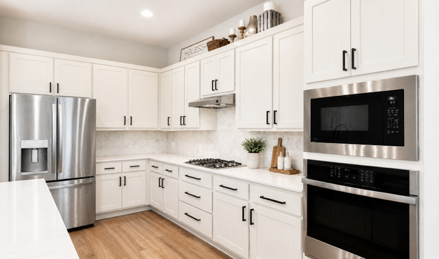 1928 Lakeside Ranch Road Georgetown, TX 78633 - Photo 11 of 37 Clean lines define this bright kitchen featuring white cabinetry, stainless steel appliances, and sleek countertops.