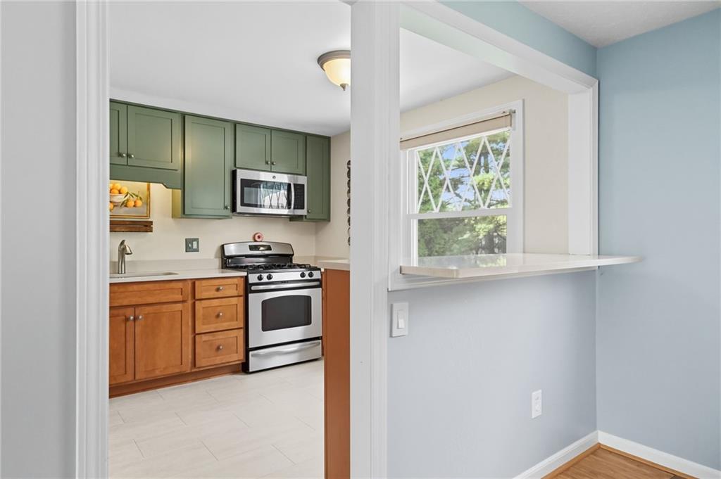 106 Kings Point Road Glenshaw, PA 15116 - Photo 12 of 49 a kitchen with stainless steel appliances granite countertop a stove a sink and a microwave