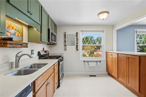 a kitchen with stainless steel appliances granite countertop a sink and a wooden cabinets