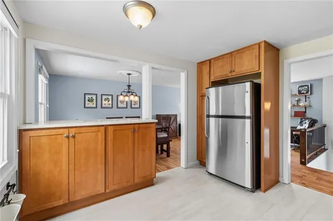 a view of a kitchen with furniture and a refrigerator