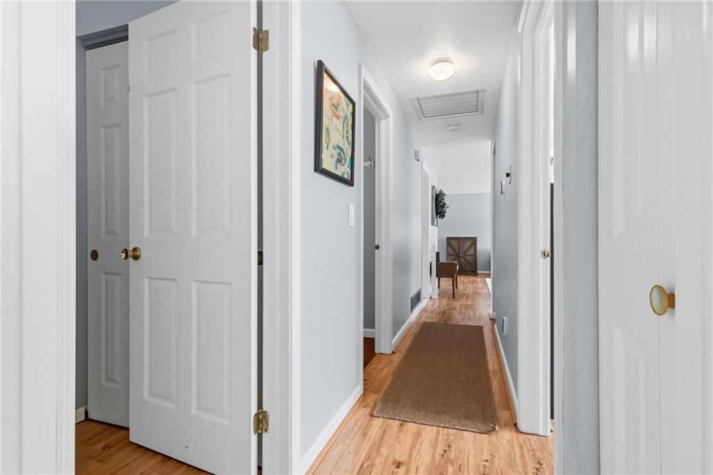 106 Kings Point Road Glenshaw, PA 15116 - Photo 17 of 49 a view of a hallway with wooden floor and a bathroom