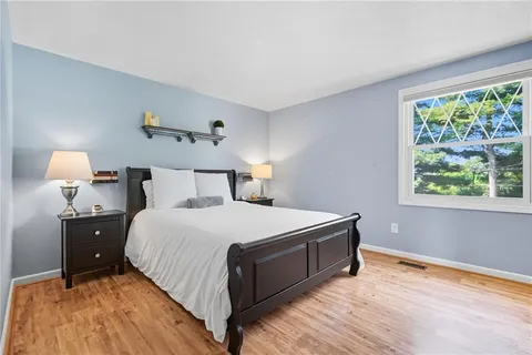 a bedroom with a bed and window