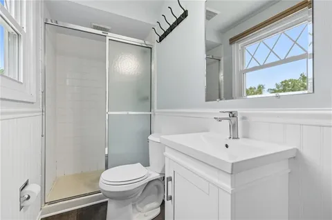 a bathroom with a sink toilet and shower