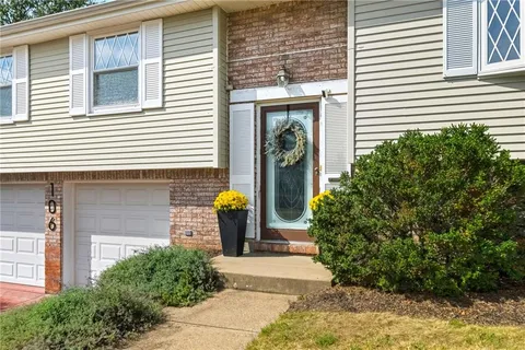 a front view of a house with a garden