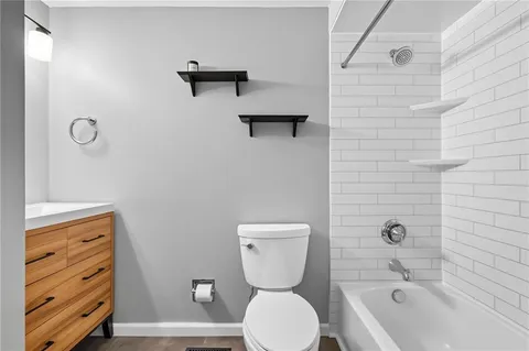 a bathroom with a toilet a sink and bathtub
