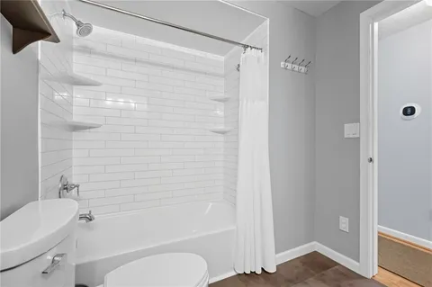 a bathroom with a shower a toilet and a sink