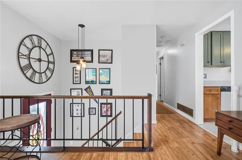 a view of a hallway with wooden floor and entryway