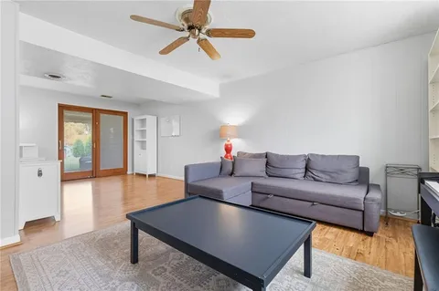 a living room with furniture and a wooden floor