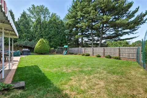 a view of a house with backyard and porch