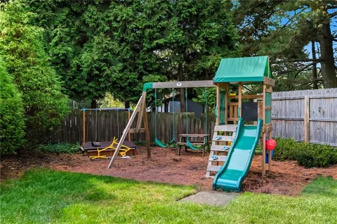 a view of yard with grass and trees