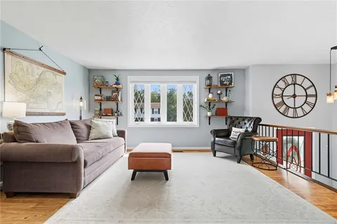 a living room with furniture a rug and a window