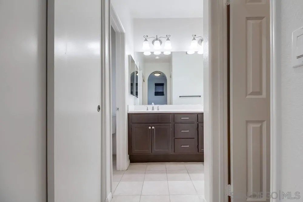 1298 Fools Gold Way, Unit 4 Chula Vista, CA 91913 - Photo 23 of 38 a bathroom with a double vanity sink and a mirror