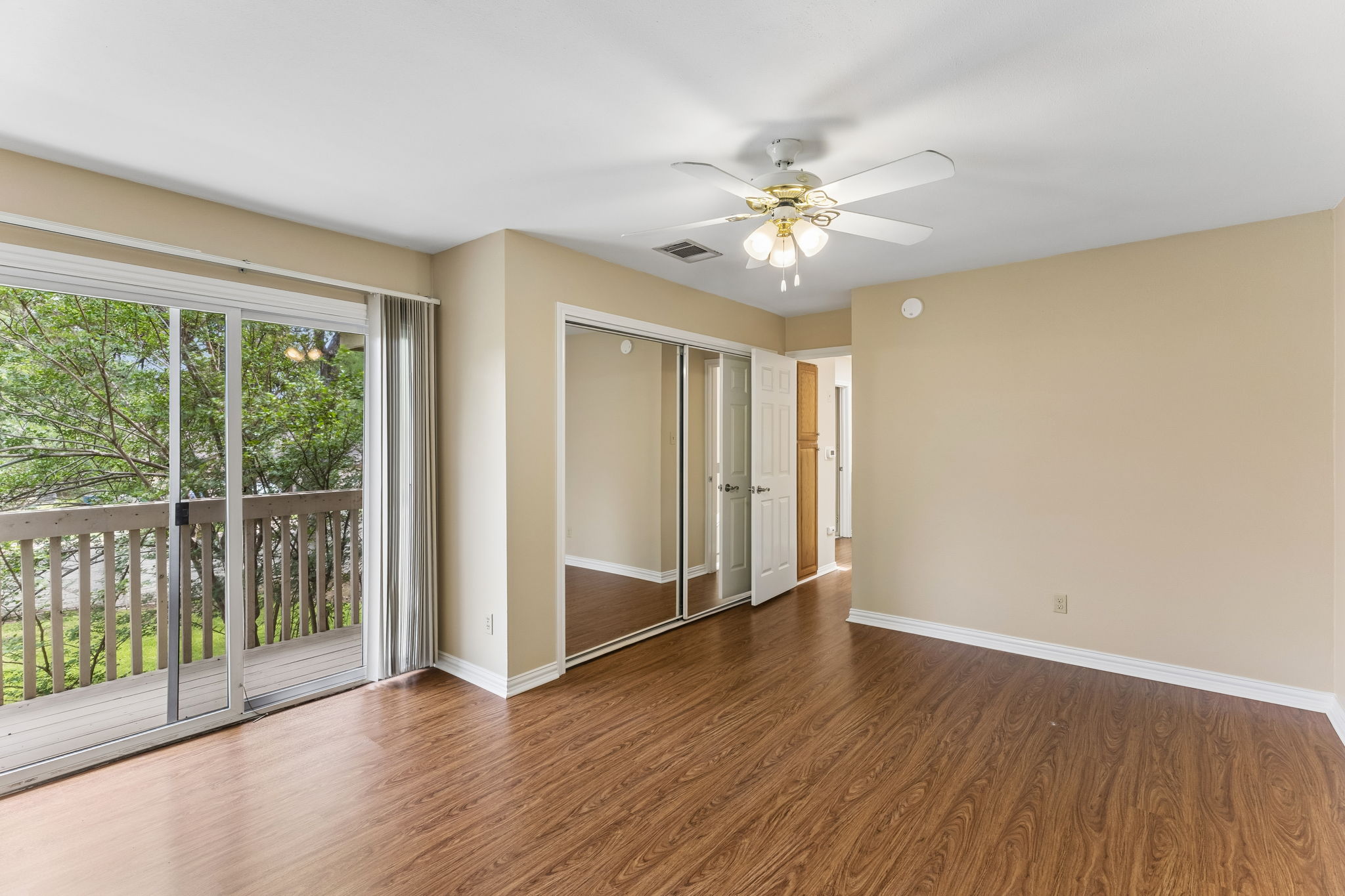 8340 Fathom Circle, Unit 103 Austin, TX 78750 - Photo 26 of 30 a view of an empty room with wooden floor and a window