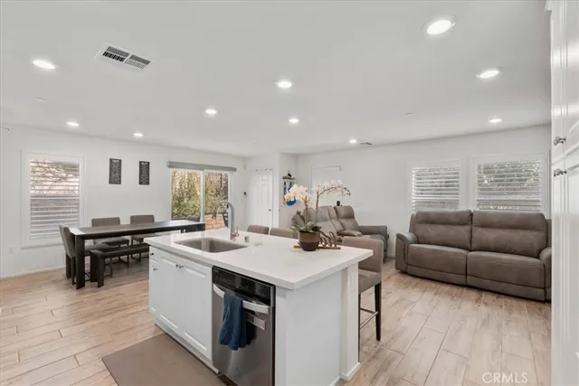 a view of kitchen island a sink and living room