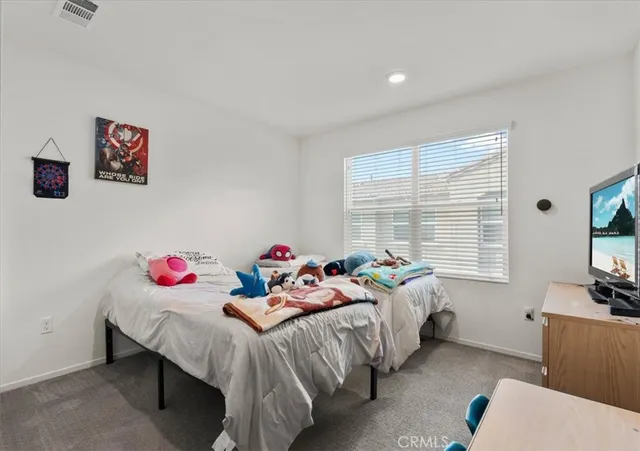 a bedroom with a bed and a dining table