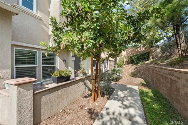 a view of house with backyard outdoor seating and plants