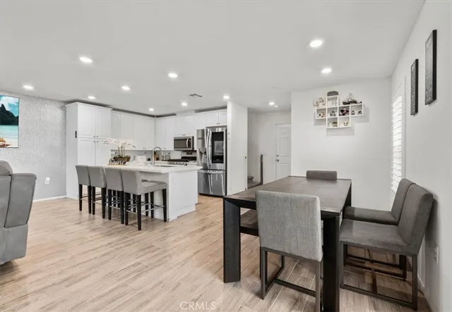 a view of a dining room with furniture and wooden floor
