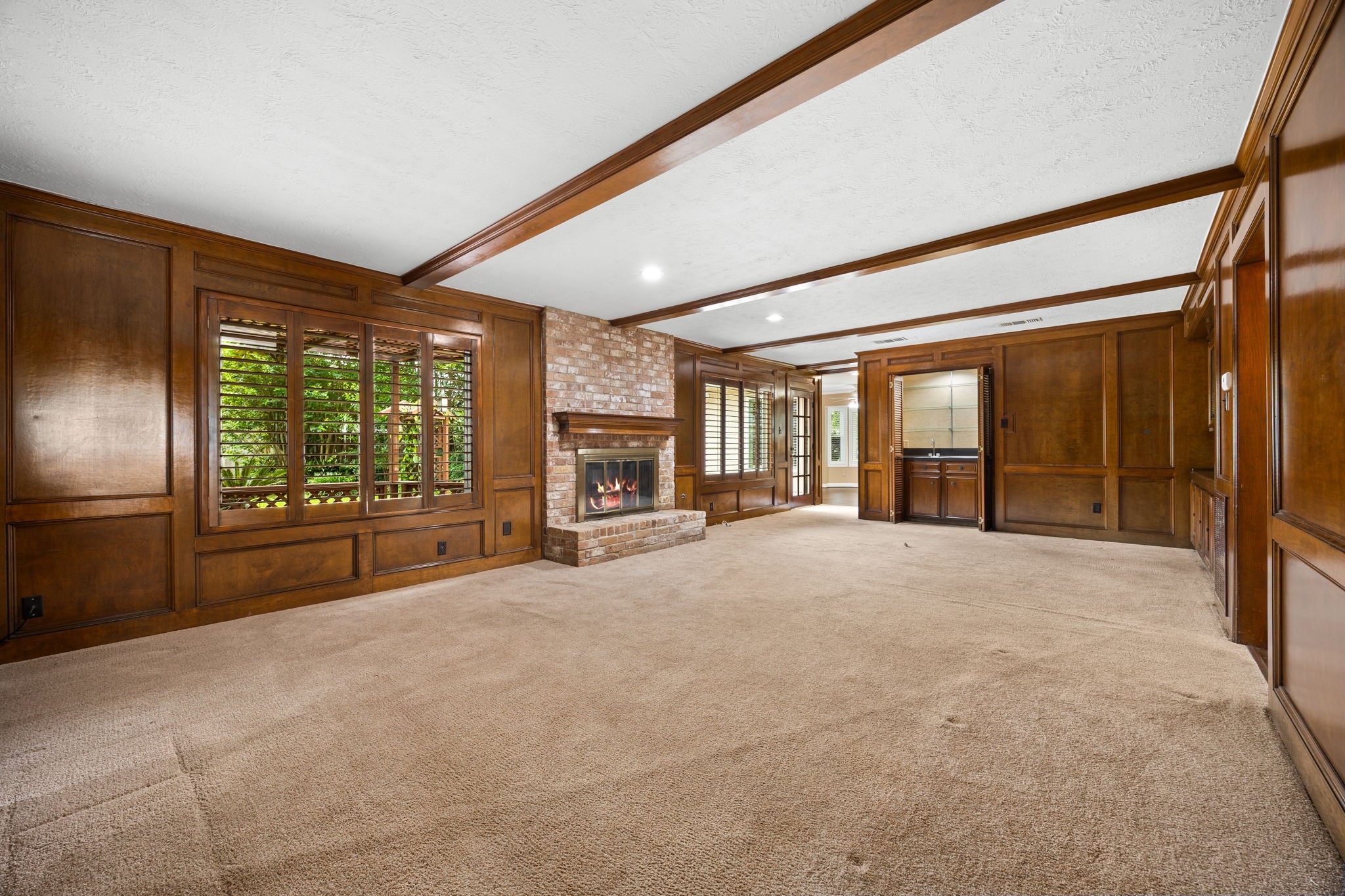 6623 Ampton Drive Spring, TX 77379 - Photo 20 of 45 Football, soccer, basketball games and lots of friends could fit in this large den. The wet bars are coming back. This house has the taller ceilings and beautiful wood paneling. Quality that is timeless.
