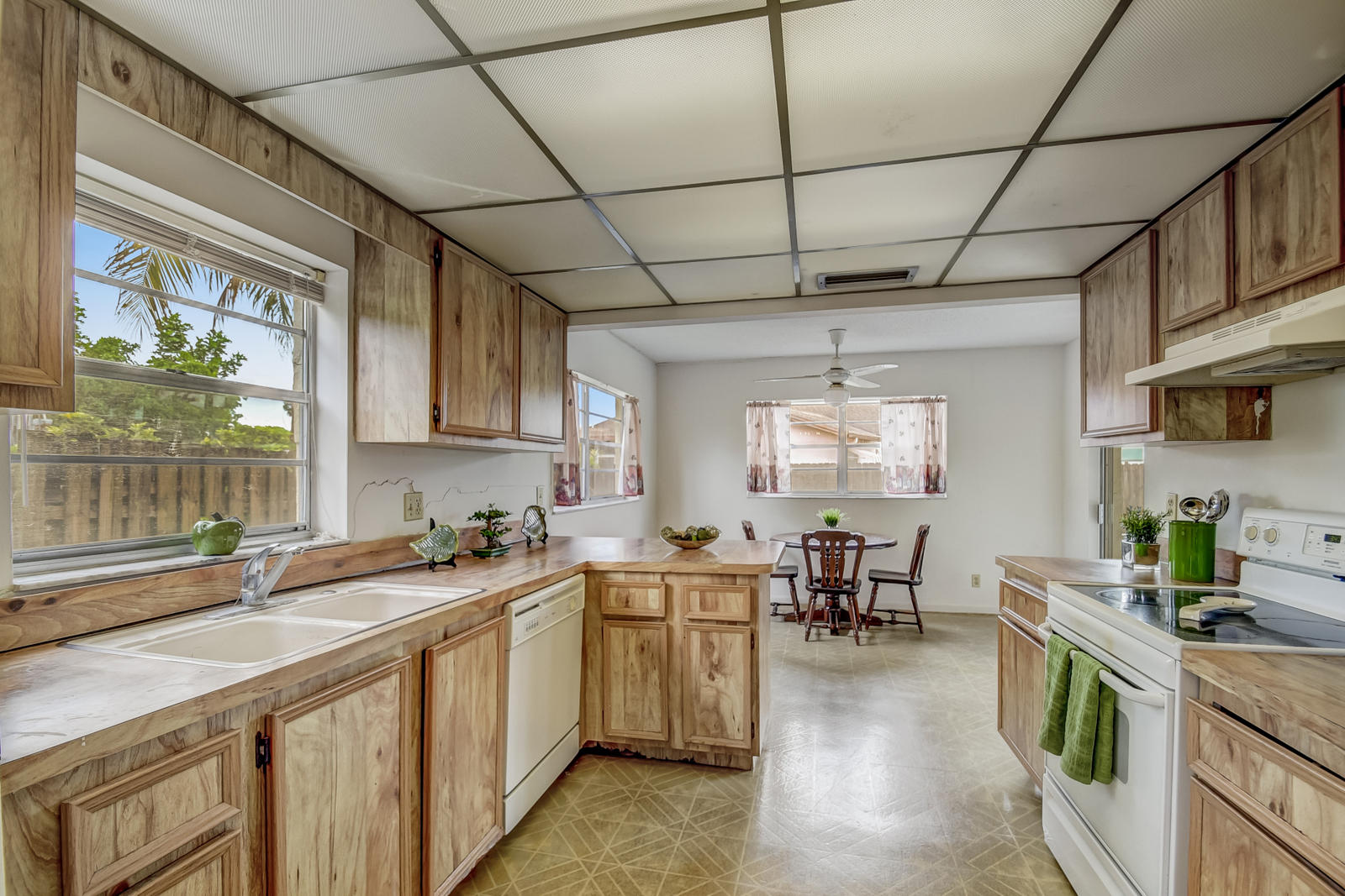 9231 Southwest 16th Road East Boca Raton, FL 33428 - Photo 14 of 32 a kitchen with a sink stove cabinets and wooden floor