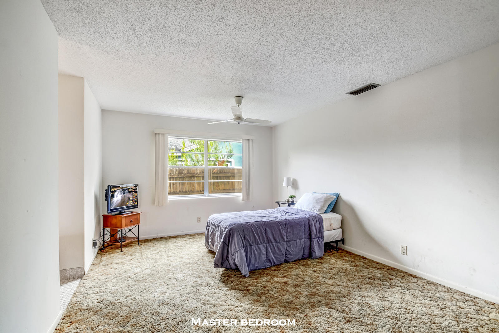 9231 Southwest 16th Road East Boca Raton, FL 33428 - Photo 18 of 32 a bedroom with a bed and a window