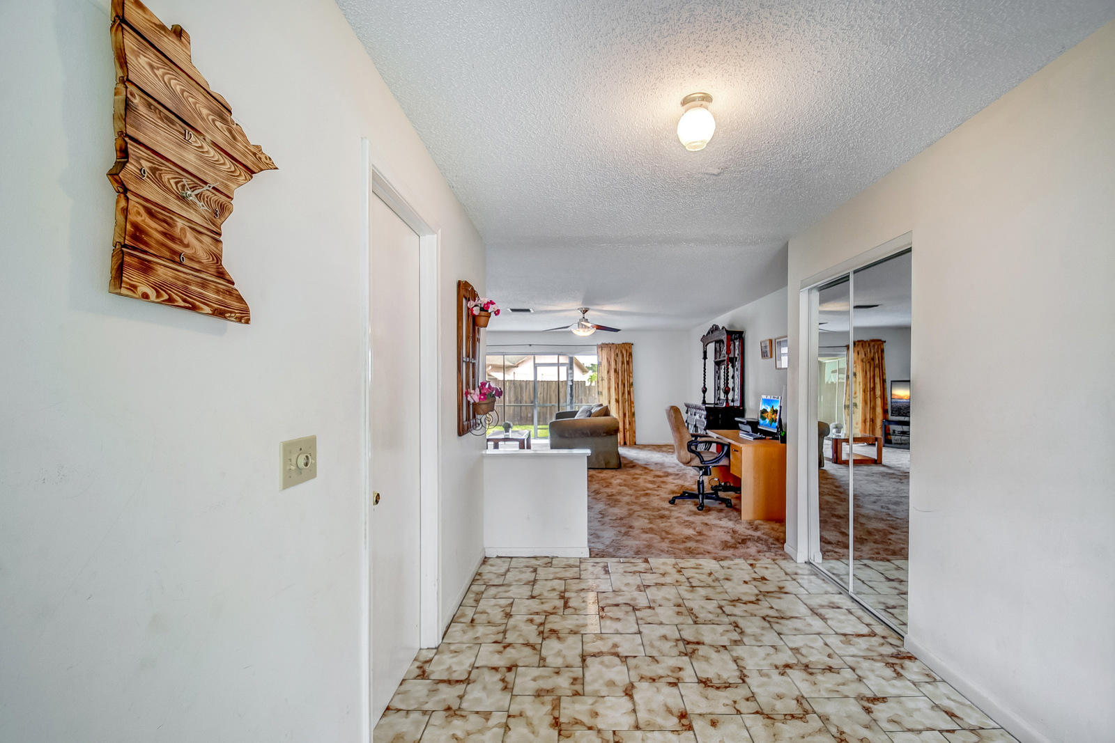 9231 Southwest 16th Road East Boca Raton, FL 33428 - Photo 3 of 32 a hallway with a couch and a window