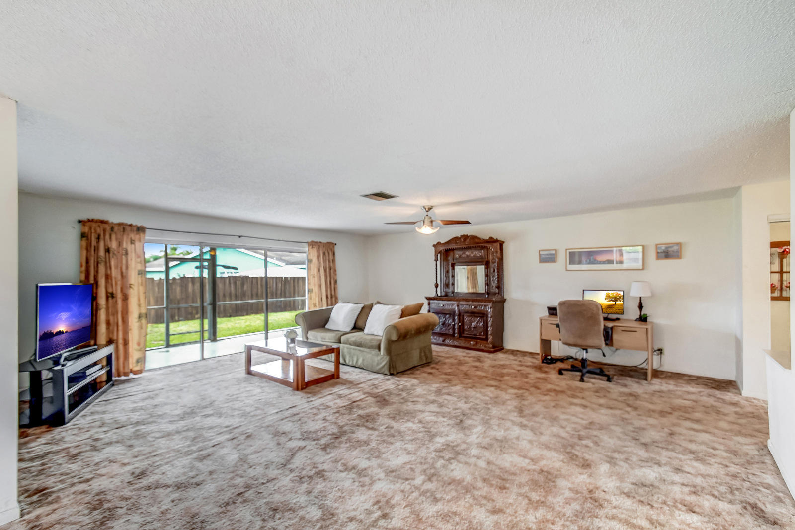 9231 Southwest 16th Road East Boca Raton, FL 33428 - Photo 6 of 32 a room with furniture and a flat screen tv