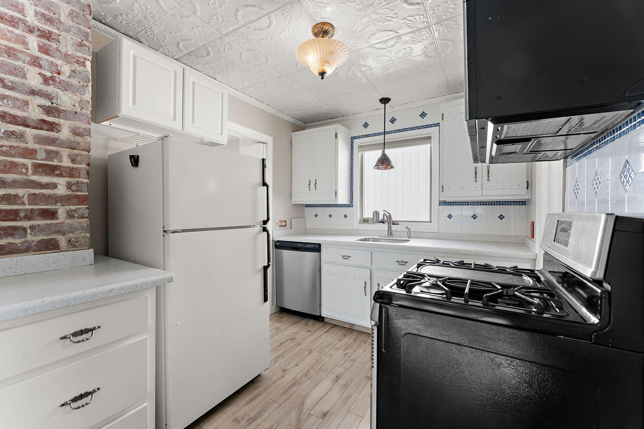 5590 East Maple Street Knox, IN 46534 - Photo 8 of 32 a kitchen with a stove a sink and a refrigerator