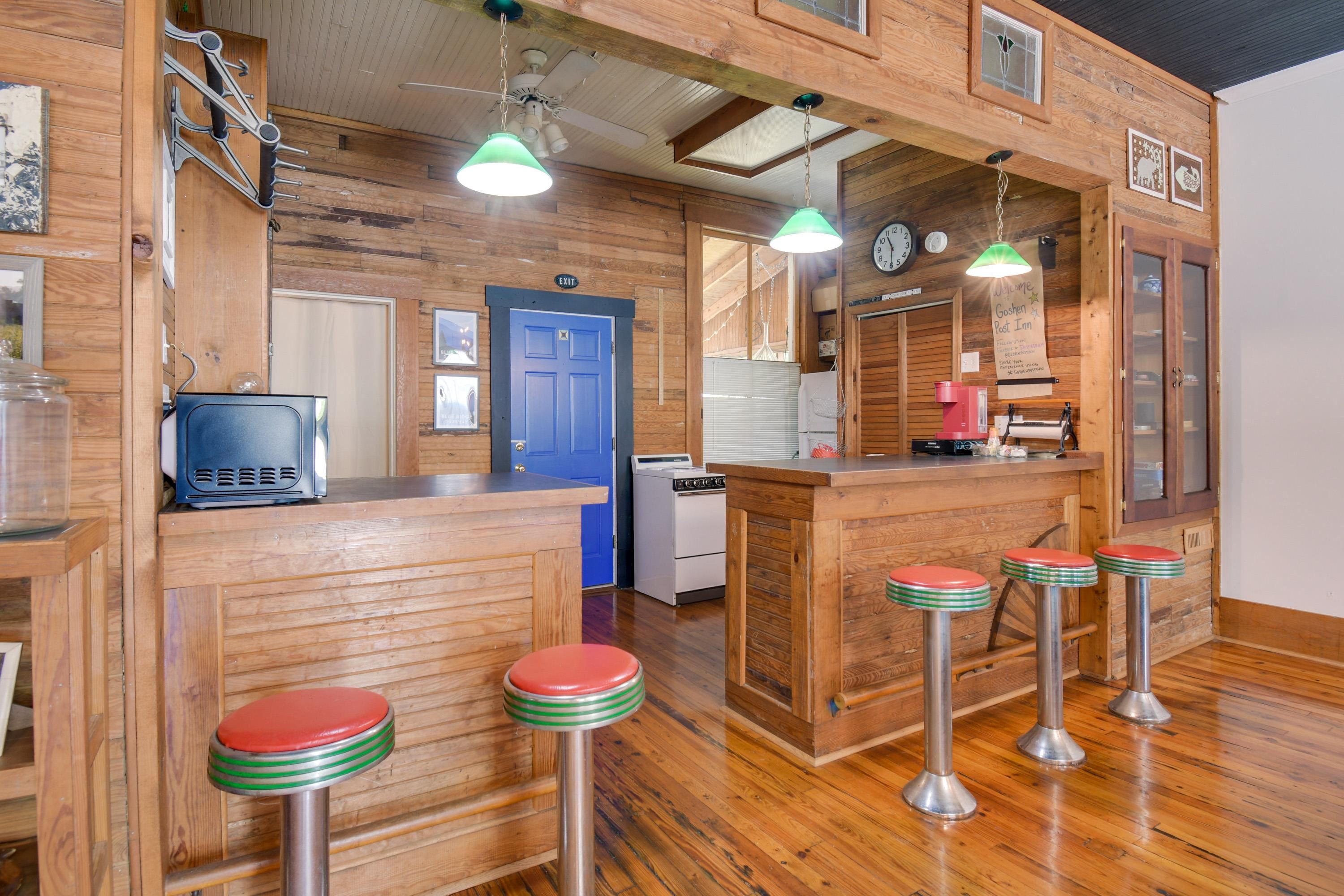 132 Main Street Goshen, VA 24439 - Photo 18 of 33 a kitchen with stainless steel appliances wooden floor and dining table