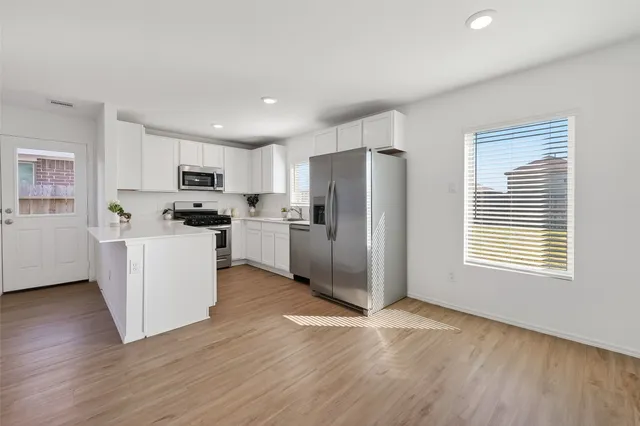a view of kitchen with furniture and wooden floor