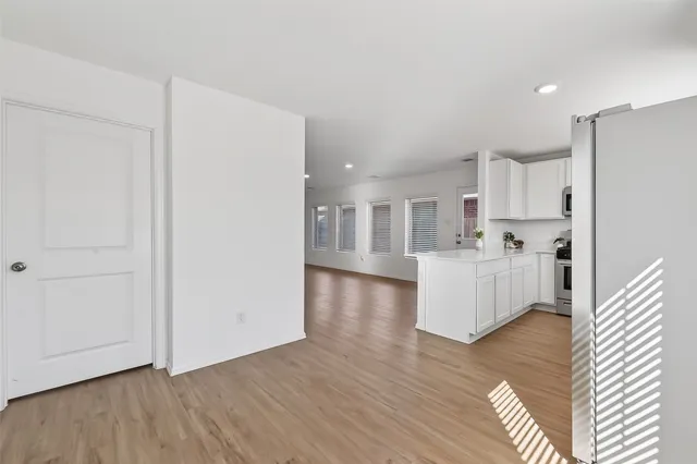 a kitchen with stainless steel appliances granite countertop a sink and dishwasher a stove top oven with white cabinets