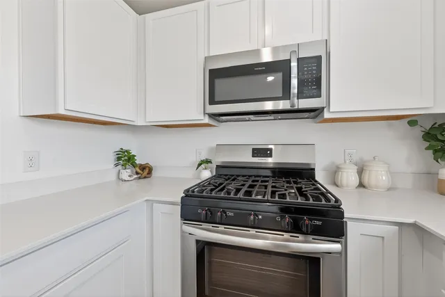 a kitchen with stainless steel appliances granite countertop a sink a counter space and cabinets