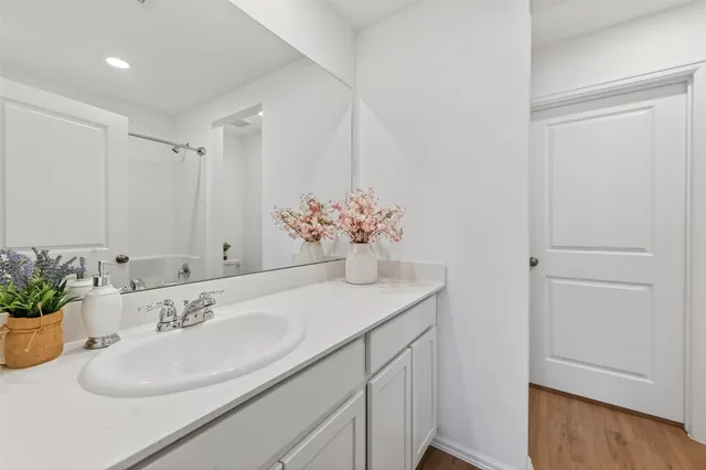 a bathroom with a sink a vanity and a mirror