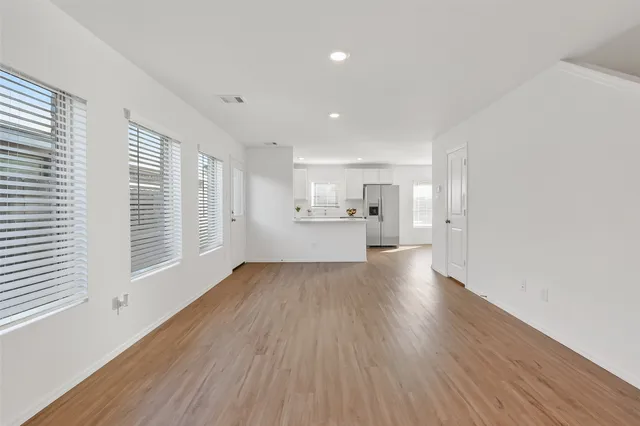 a view of a kitchen with wooden floor and a sink